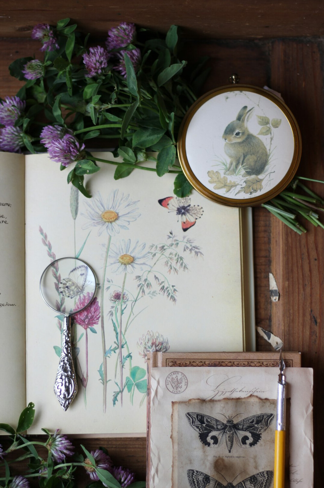 Vintage magnifying glass on an open handwritten notebook