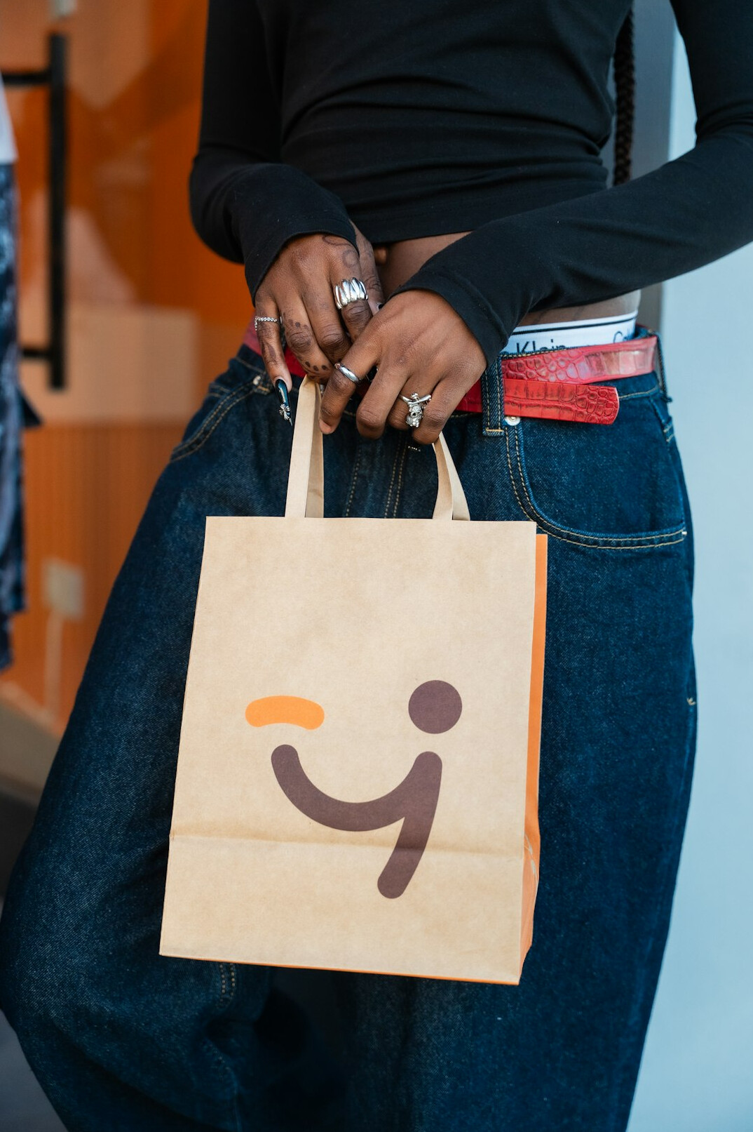man hiding merchandise in bag